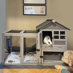 there is a dog that is sitting in the house with his head inside the cage