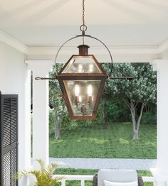 a light hanging from the ceiling over a porch