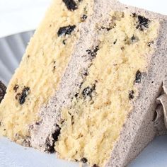 a piece of cake sitting on top of a white plate next to an oreo cookie