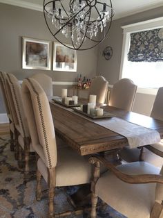 a dining room table with chairs and a chandelier