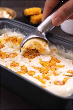 a person scooping some food out of a pan