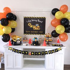 a construction themed birthday party with black, yellow and orange balloons