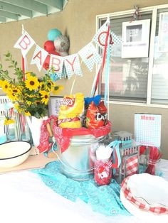 a baby shower is set up outside on the patio with sunflowers and decorations