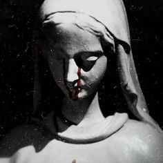 a creepy looking statue with blood dripping from it's mouth