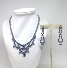 "Vintage Estate Blue Rhinestone AB Waterfall Necklace And Dangle Earrings  This lovely piece can be worn on any occasion and is absolutely beautiful in the light, both inside and out, the perfect gift for anyone who loves vintage jewelry.  - Measures Approx.  - Each order comes shipped in a small drawstring pouch, all ready for     gifting. -If you are wanting to have this mailed as a gift to a special someone,  please write their address in the note section, otherwise it will be  mailed to you. -If you would like to add a special typed note added to the order, please  type that into my \"note to seller\" and we can add that special  message. Thank You so much for visiting Paradise Vintage Jewelry Shop Diana Waggoner 1630@011" Vintage Blue Necklace For Evening, Blue Crystal Necklace Costume Jewelry, Blue Vintage Crystal Necklaces, Vintage Blue Single Strand Necklace, Small Drawstring Pouch, Vintage Necklaces Blue Rhinestones, Waterfall Necklace, Lipstick Holder, Dance Shirts