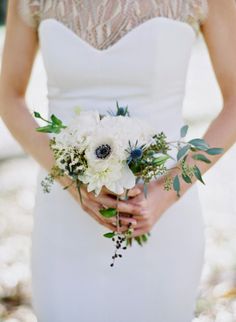 a woman in a white dress holding a bouquet