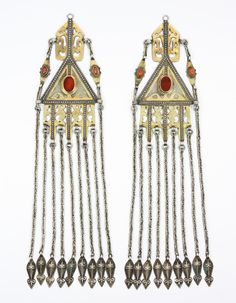 Turkmenistan | Fire-gilt silver with carnelian temple pendants or "tenecir" are worn hanging from thick hair braids by the Tekke Turkmen women. | These are from the late 1800's to early 1900's. Gold Sheets, A3 Poster, Silver Ornaments, Ancient Jewelry, Traditional Jewelry, Ethnic Jewelry, Metropolitan Museum Of Art, Metropolitan Museum