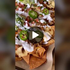 an image of nachos with cheese and green peppers