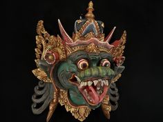 an elaborate mask is displayed against a black background