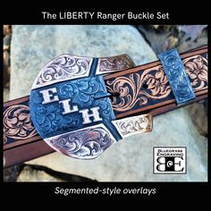 "Treat yourself or a special someone to a custom made ranger buckle set, crafted with care and skill from the best materials by Bluegrass Engraving. Our steel buckles feature overlays that are hand sawn from your choice of metals, and hand engraved in our studio by Brian Ferrand. Unlike many others that are cold-blued, our steel buckles are finished with a hot-blued process for a deep, lustrous finish that also serves to protect the steel. Care instructions are provided with your order. Two-piece handcrafted steel ranger belt buckle set for a 1.5\" width belt: The Liberty shape steel buckle and keeper, overlaid with your choice of metals Segmented-style overlays on the buckle sides Buckle measures approx 3 5/8\" tall x 4\" across Personalized with your ranch brand, initials, Masonic logo, Ranger Belt, Shopping Apps, Custom Belt Buckles, Western Belt Buckles, Custom Belt, Gifts For Fiance, Branded Belts, Western Belts, Men Jewelry