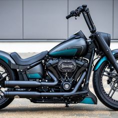 a black and blue motorcycle parked in front of a building