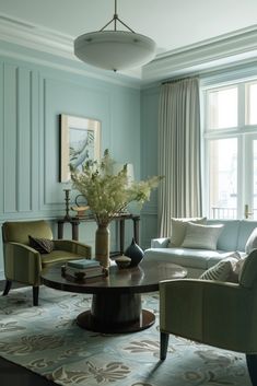 a living room with blue walls and furniture