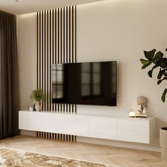 a flat screen tv mounted to the side of a white entertainment center in a living room