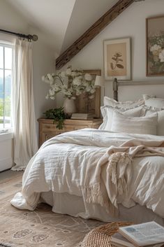 a bed with white linens and pillows in a bedroom next to an open window