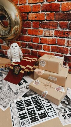 an owl figurine sitting on top of a table next to boxes and papers