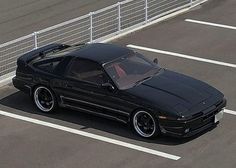 a black sports car parked in a parking lot