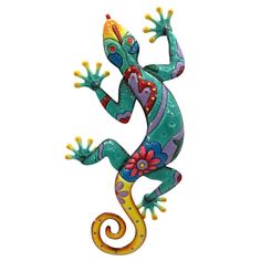 a colorful lizard statue sitting on top of a white wall