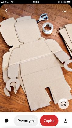 cut out pieces of cardboard sitting on top of a wooden floor