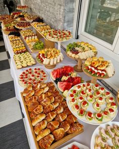 a table filled with lots of different types of pastries and desserts on it