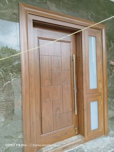 an open wooden door with glass on the outside