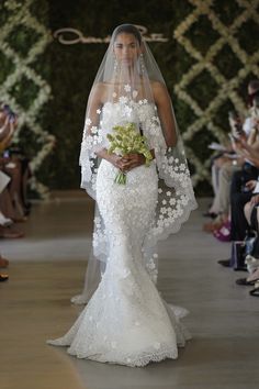 a woman in a white wedding dress and veil