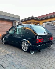 a black car parked in front of a house