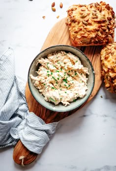 chicken salad in a bowl with bread on the side