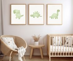 a baby's room with three green prints on the wall and a crib