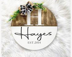 a wooden sign that says hayes est 2012 with a bow on it and the words hayes est 2014