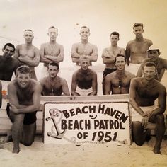 an old black and white photo of men in bathing suits on the beach with a sign that says beach haven beach patrol of 1932