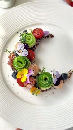 a white plate topped with fruit and veggies