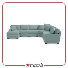 a blue sectional couch with pillows on the top and bottom corner, in front of a red frame