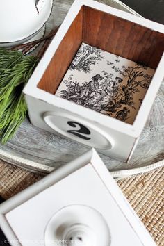 an open box sitting on top of a table next to a cup and saucer