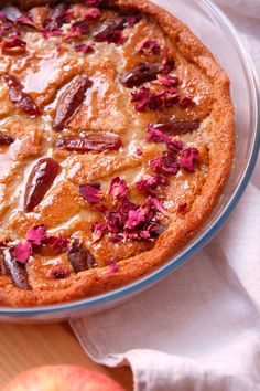 an apple pie with pink flowers on top