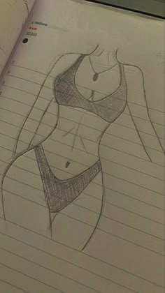 a drawing of a woman's torso in pencil on lined paper with an open notebook