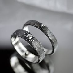 two silver rings sitting on top of each other