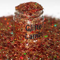 a jar filled with glitter sitting on top of a table