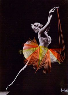 a ballerina in the air with an orange and yellow string on it's skirt