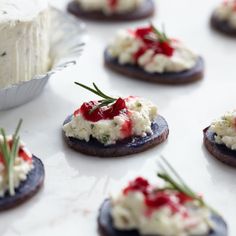 small crackers with cream cheese and red sauce on them