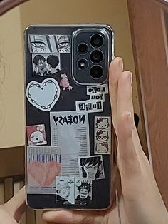 someone holding up their cell phone case with stickers on it and the back cover