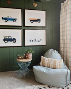 a living room with green walls and pictures on the wall