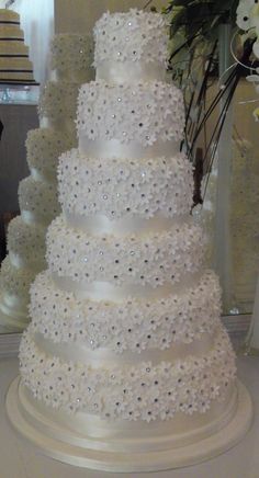 a large white wedding cake sitting on top of a table