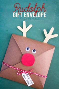 an envelope with reindeer antlers on it and the words rudolph gift envelope written in red