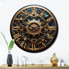 a gold and black clock sitting on top of a wooden table next to a vase