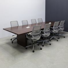 an empty conference table with chairs around it