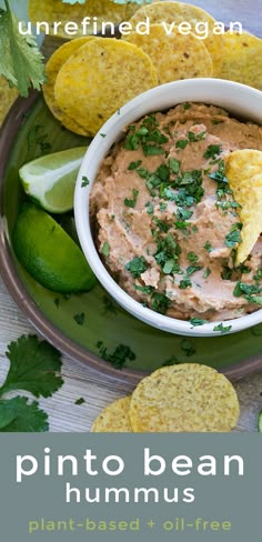 a plate with chips, guacamole and tortilla chips