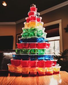 a stack of plastic containers sitting on top of a wooden table