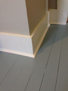 an empty room with wood floors and white paint on the walls is pictured in this image