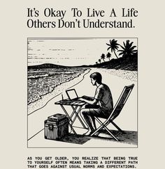 a man sitting at a table on top of a beach next to the ocean