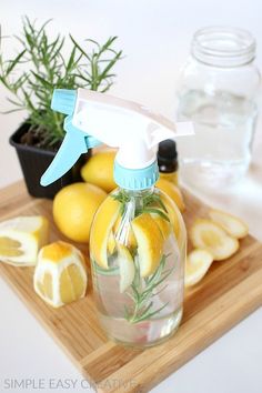 lemons and rosemary are used to make diy all - purpose cleaner on a cutting board